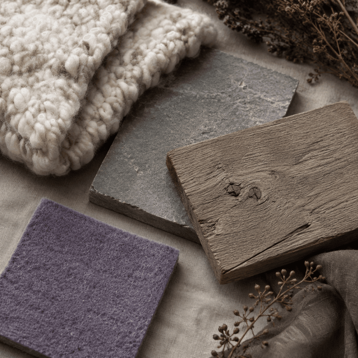 A flat material board with wool, stone, wood and heather felt swatches